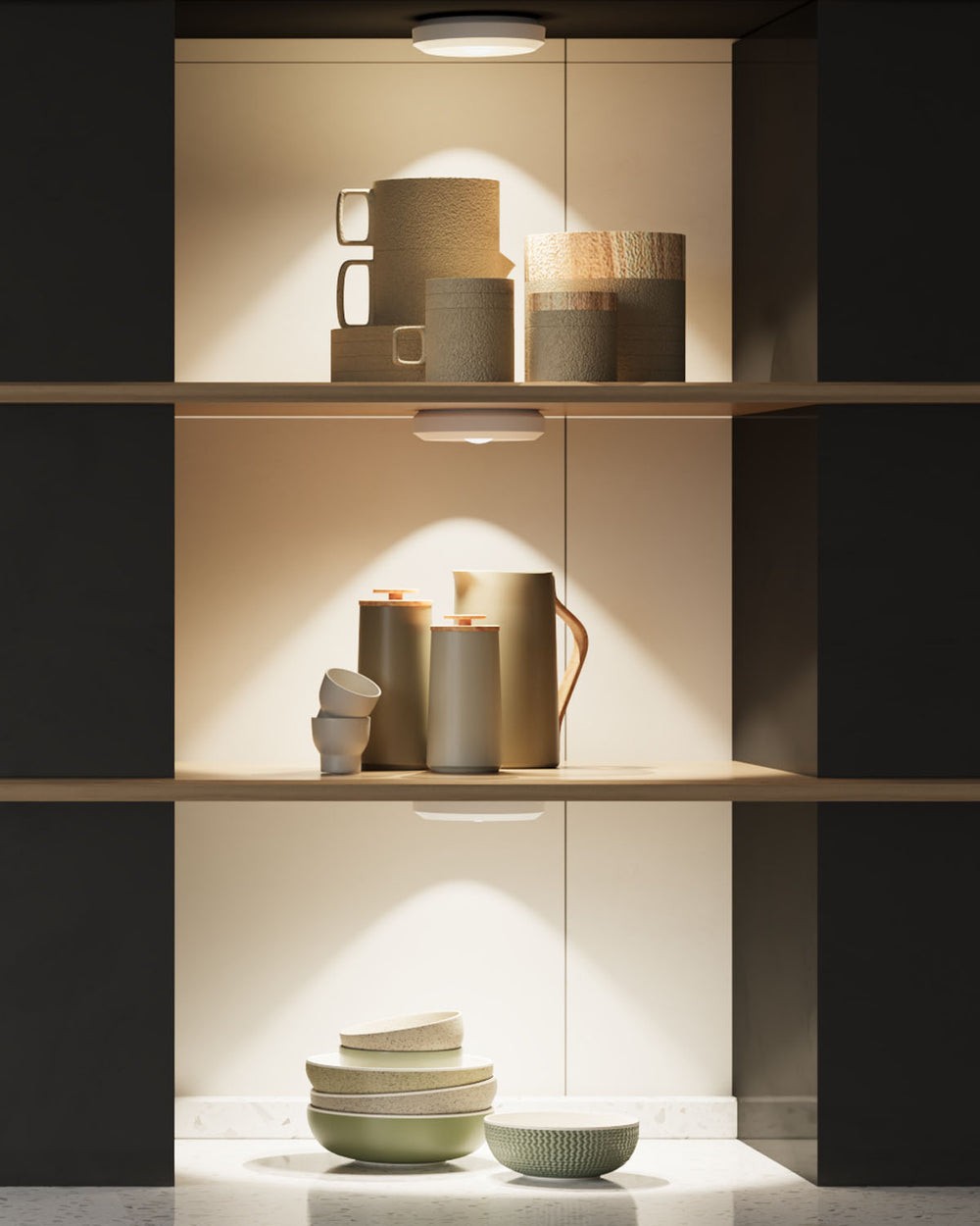 Ceramic mugs and bowls on a shelf with soft puck lights
