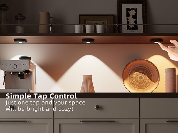 Modern kitchen with a hand reaching for puck light led tap lights fixture, text about simple tap control.