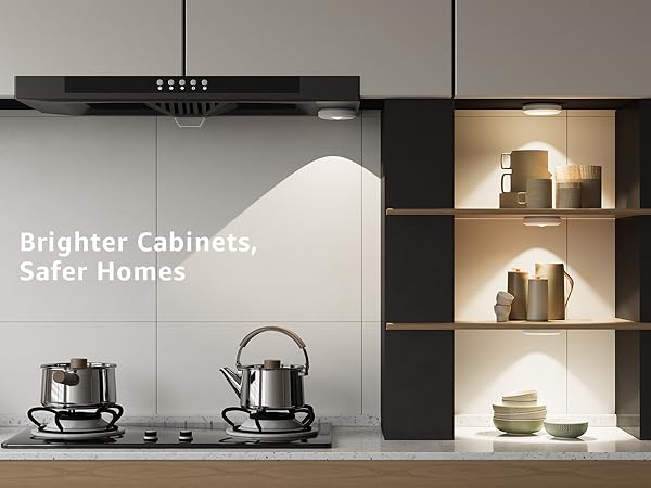 Modern kitchen with cabinets labeled 'Brighter Cabinets, Safer Homes' with puck lights under cabinet lighting
