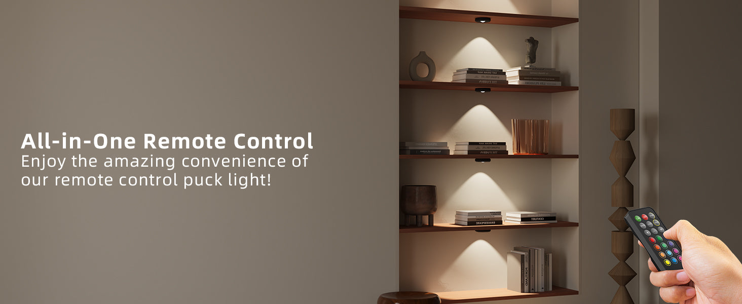 Shelving puck light with decorative items and a hand holding an all-in-one remote control.