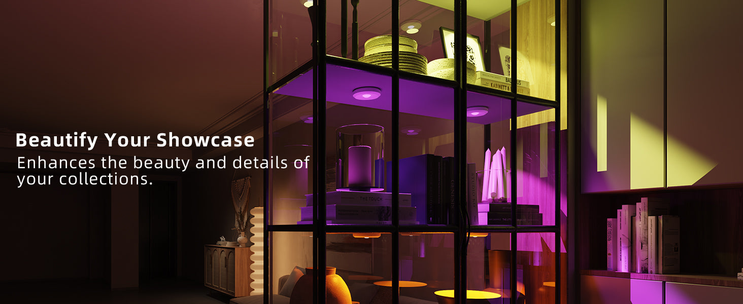 Modern glass showcase display with illuminated interior displaying various items illuminated by RGB rechargeable puck lights