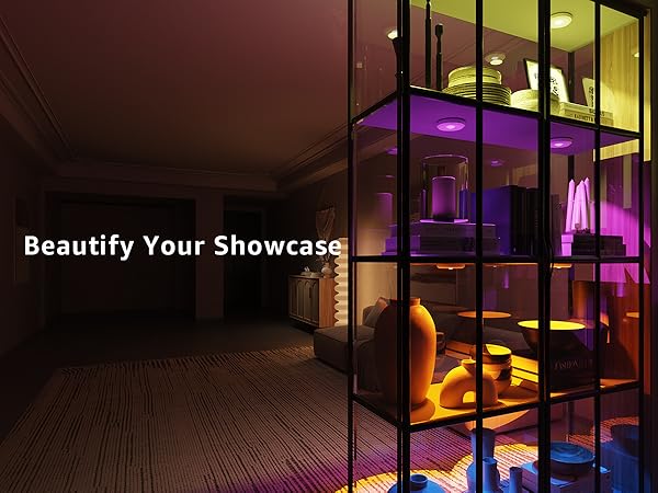 Modern interior design with glass partition, furniture, and decorative items lighted by rechargeable puck lights RGB 